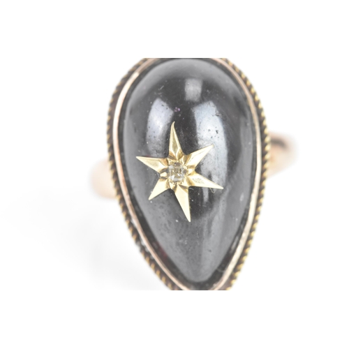 61 - A Victorian garnet cabochon and diamond yellow gold star ring, the central tear-drop garnet centred ... 