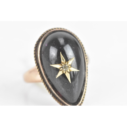 61 - A Victorian garnet cabochon and diamond yellow gold star ring, the central tear-drop garnet centred ... 