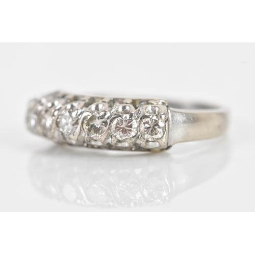 62 - A 19th century diamond silver ring, having seven old brilliant cut diamonds, the central stone appro... 