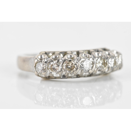 62 - A 19th century diamond silver ring, having seven old brilliant cut diamonds, the central stone appro... 