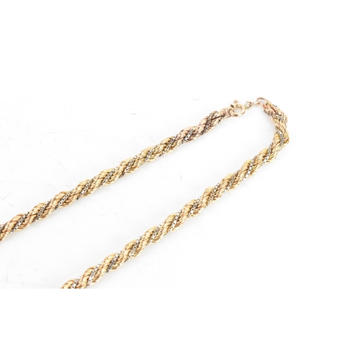 7 - A 9ct gold bi-coloured rope twist necklace, having a bolt ring clasp, stamped 375, 46cm, 16.9 grams
... 