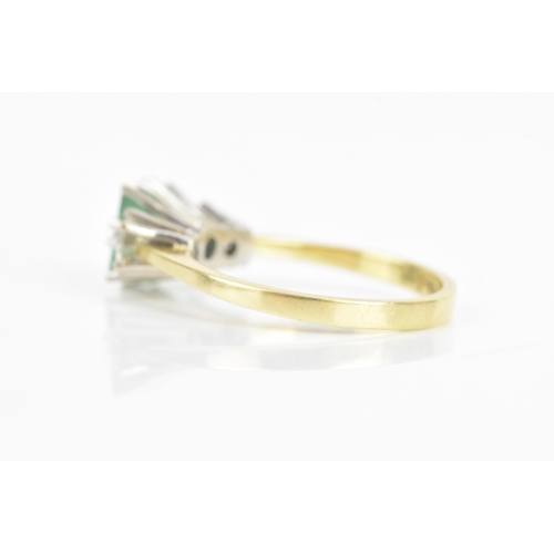 72 - An emerald and diamond 18ct yellow and white gold ring, the central emerald 6.3mm x 5.4mm, flanked b... 