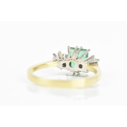 72 - An emerald and diamond 18ct yellow and white gold ring, the central emerald 6.3mm x 5.4mm, flanked b... 