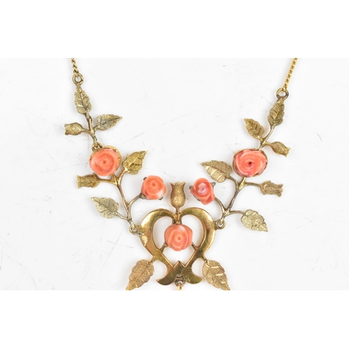 9 - An Art Nouveau coral necklace, the six carved corals fashioned as roses set within a yellow metal fl... 