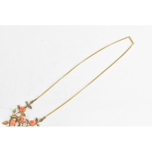 9 - An Art Nouveau coral necklace, the six carved corals fashioned as roses set within a yellow metal fl... 