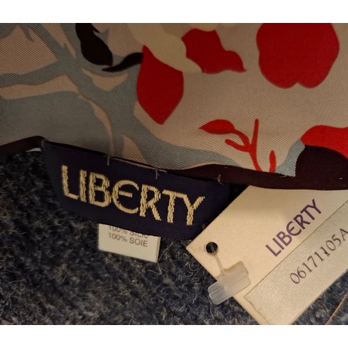 20 - Liberty- A 1980's un-used silk scarf with original tags having a cream, salmon pink, pale blue and b... 