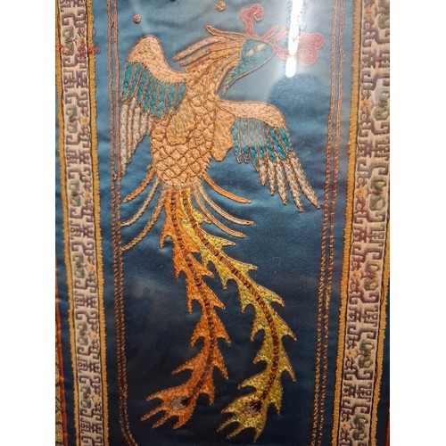 38 - Two 20th Century framed embroidered panels, one depicting a fire dragon on a blue silk ground surrou... 