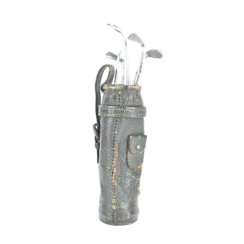 253 - Circa 1930s, A Hermes miniature leather golf bag containing a manicure set in the form of golf irons... 