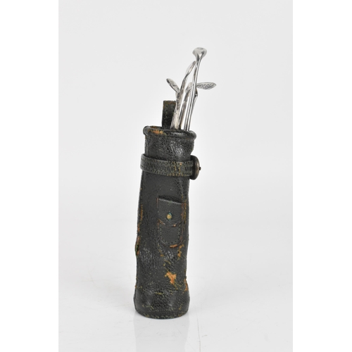 253 - Circa 1930s, A Hermes miniature leather golf bag containing a manicure set in the form of golf irons... 