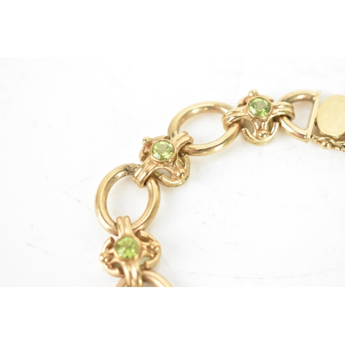 258 - A peridot 9ct gold chain link bracelet, having oval links and with eight faceted green peridots, eac... 