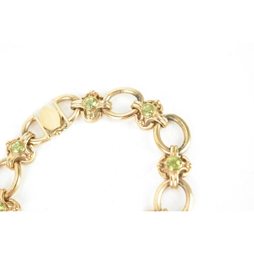 258 - A peridot 9ct gold chain link bracelet, having oval links and with eight faceted green peridots, eac... 