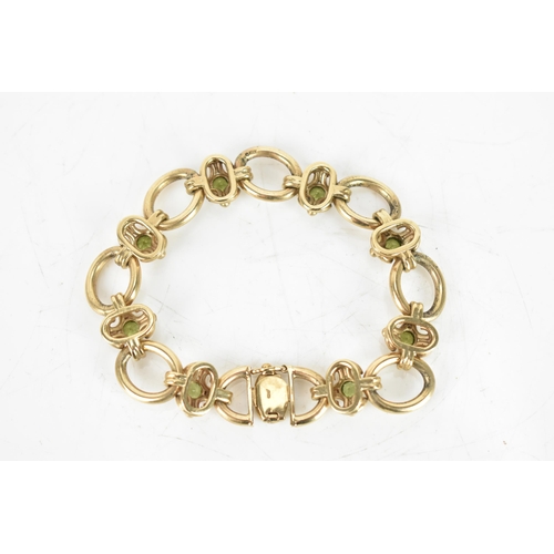 258 - A peridot 9ct gold chain link bracelet, having oval links and with eight faceted green peridots, eac... 