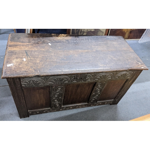 406 - A late 17th century oak coffer having a hinged top with a carved panelled front, 61cm h x 107cm w
Lo... 