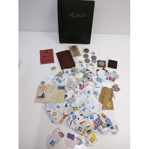 491 - A collection of used postage stamps together with a World stamp album, some commemorative coins and ... 