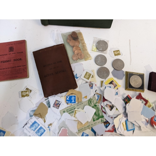 491 - A collection of used postage stamps together with a World stamp album, some commemorative coins and ... 