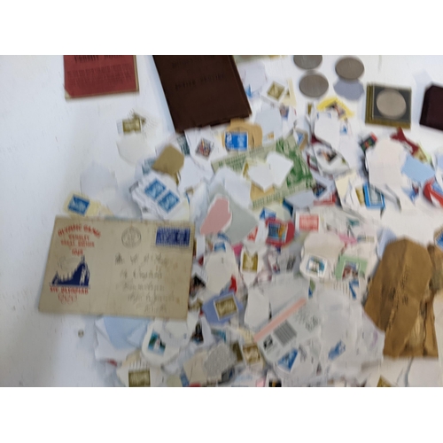 491 - A collection of used postage stamps together with a World stamp album, some commemorative coins and ... 