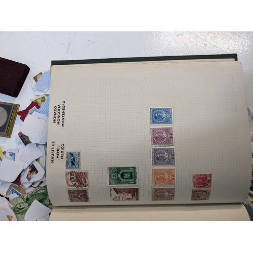 491 - A collection of used postage stamps together with a World stamp album, some commemorative coins and ... 