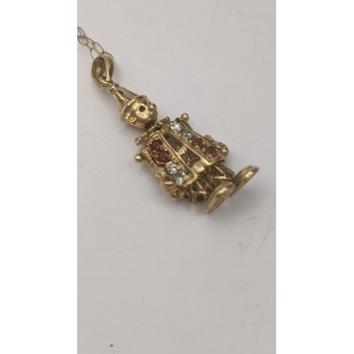 197 - A 9ct yellow gold Clown pendant set with coloured paste stones with moving limbs on a chain link nec... 