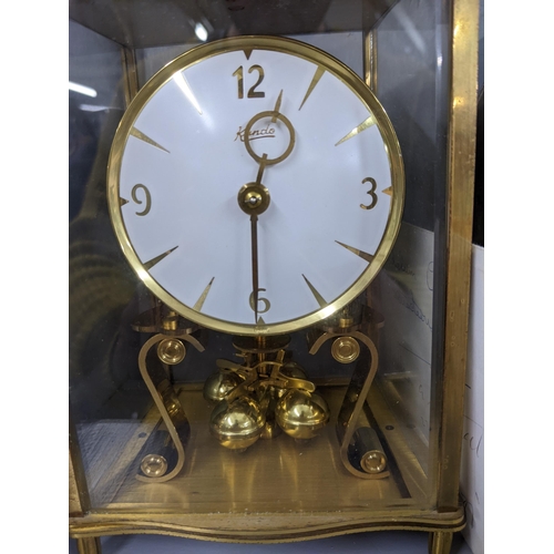 216 - Three clocks, a quartz circular desktop clock on a wooden                                           ... 