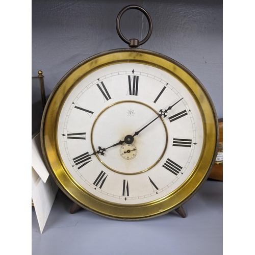 216 - Three clocks, a quartz circular desktop clock on a wooden                                           ... 