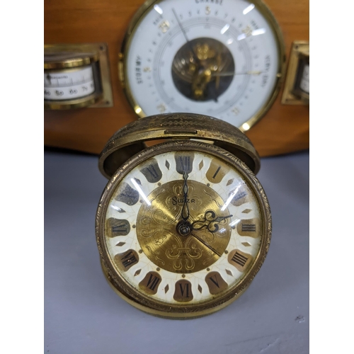 216 - Three clocks, a quartz circular desktop clock on a wooden                                           ... 