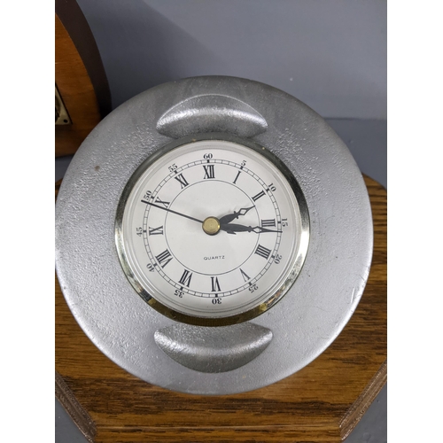 216 - Three clocks, a quartz circular desktop clock on a wooden                                           ... 