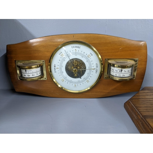 216 - Three clocks, a quartz circular desktop clock on a wooden                                           ... 