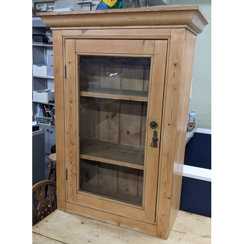 325 - An early 20th century pine wall hanging cabinet with a single glazed door, 106cm h x 76cm w
Location... 