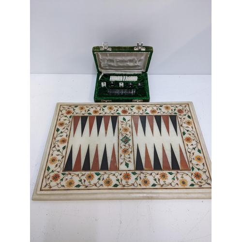 409 - A Backgammon set with cased pieces with a quartz board, marquetry inlay sitting a wooden table
Locat... 