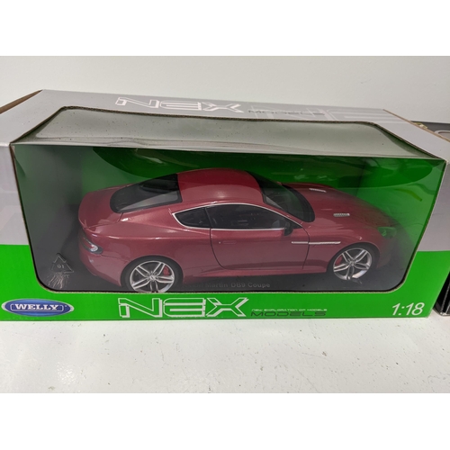 447 - Two boxed Diecast 1/18 scale model vehicles to include a Welly Nex models series Aston Martin DB9 Co... 