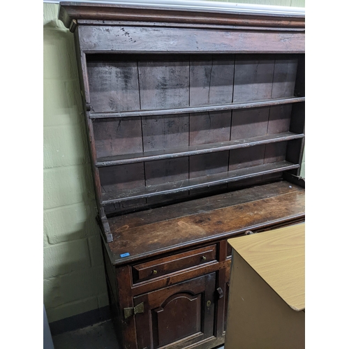 456 - An 18th century Georgian oak Welsh dresser, the plain top with three open shelves, the base with one... 