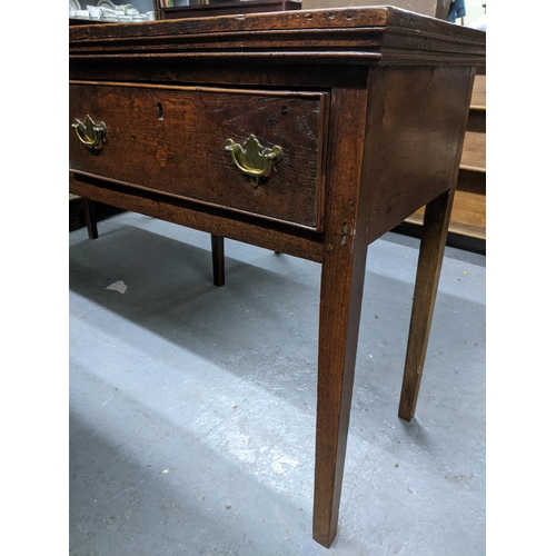 468 - A Georgian oak dresser base, three frieze drawers with brass swan neck handles on square tapering le... 