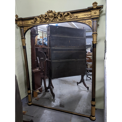 477 - A 19th century Regency style ebonized and gilt framed wall mirror with scrolled leaf and neo-classic... 