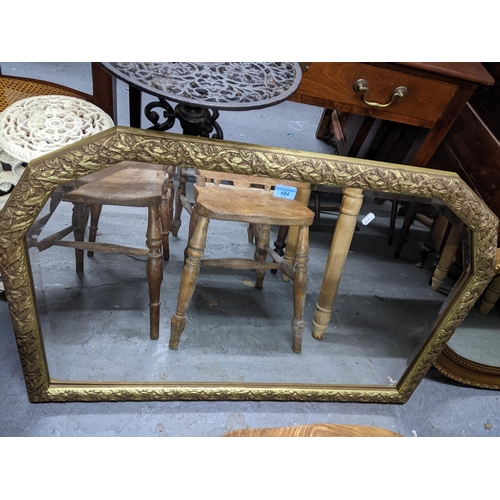 484 - Two gilt framed wall mirrors, an oval mirror, and an overmantel mirror with leaf and berry decoratio... 