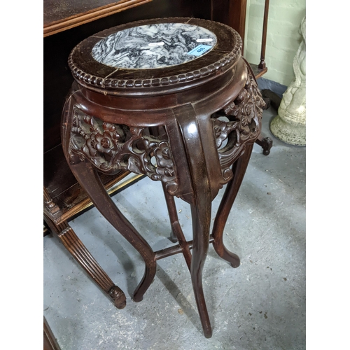 486 - A Chinese carved hardwood jardiniere stand with inset marble top, pierced prunus blossom decoration,... 