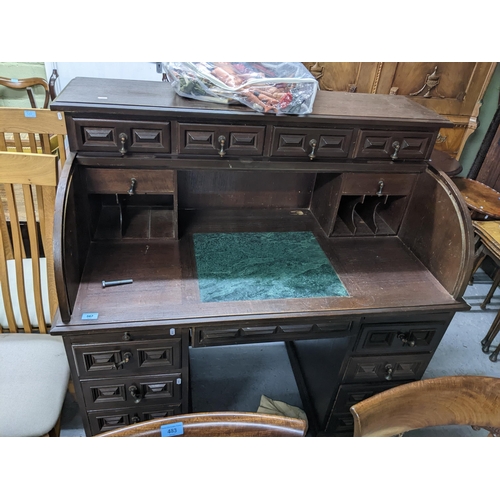 567 - An early 20th century oak roll top desk having fitted interior with pigeon holes and storage space, ... 