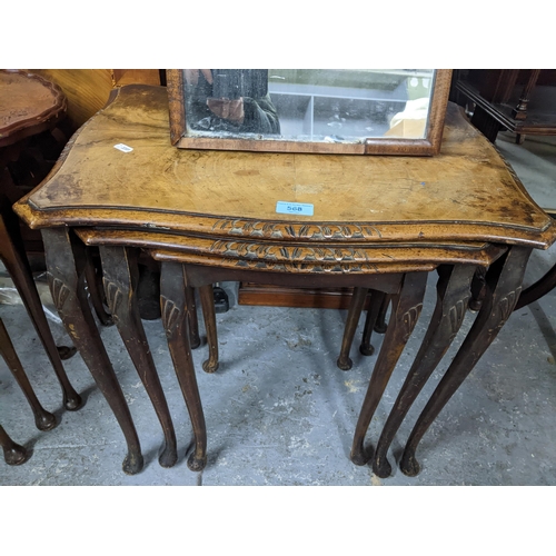 568 - Two early 20th century walnut veneered nests of three tables and a walnut framed strut dressing tabl... 