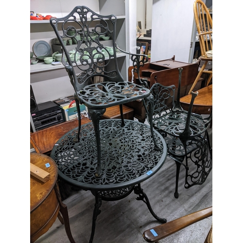 570 - A green painted aluminium two tier garden table with circular top and three garden chairs
Location: ... 