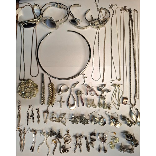 54 - A quantity of mainly modern silver costume jewellery to include earrings, fine chains and bangles. L... 