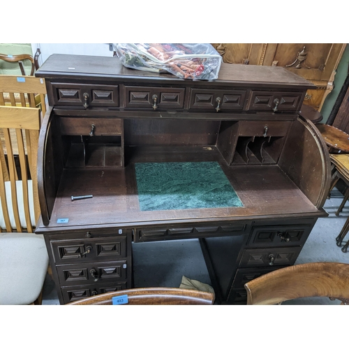 405 - An early 20th century oak roll top desk having fitted interior with pigeon holes and storage space, ... 