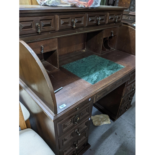 405 - An early 20th century oak roll top desk having fitted interior with pigeon holes and storage space, ... 
