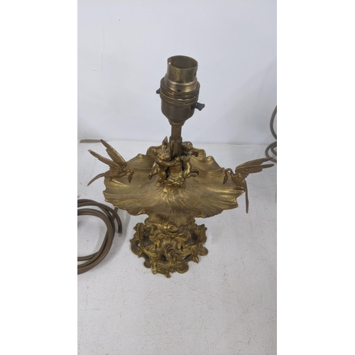 12 - An early 20th century gilt table lamp fashioned as a water lily with cherubs and swans, 26cm 
Locati... 