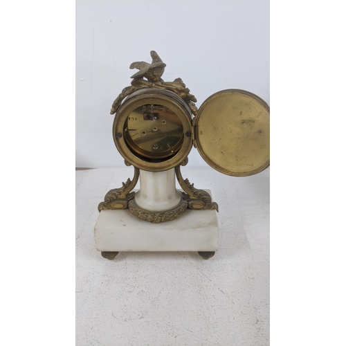 14 - A late 19th century French marble and gilt metal mantel clock having a floral enamel dial and gilt h... 