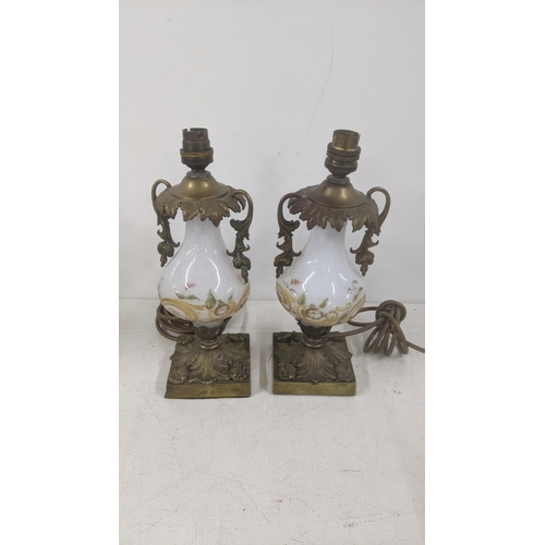 15 - A pair of late 19th century to early 20th century bronze and glass table lamps having floral hand pa... 