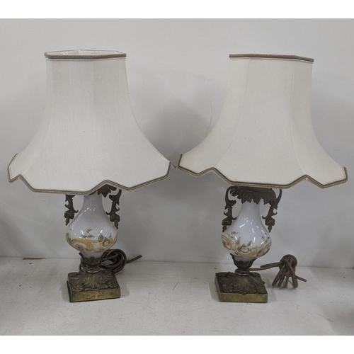 15 - A pair of late 19th century to early 20th century bronze and glass table lamps having floral hand pa... 