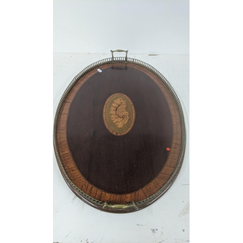 23 - An Edwardian mahogany marquetry inlaid oval having tray having brass twin handles
Location:A3F
If th... 