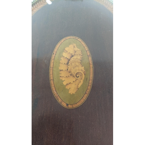 23 - An Edwardian mahogany marquetry inlaid oval having tray having brass twin handles
Location:
If there... 