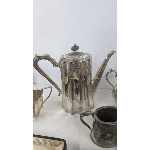 24 - A selection of silver plated items to include a Mappin & Webb coffee pot having floral engraved deco... 