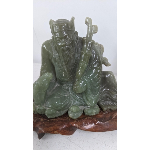 34 - Two jade sculptures to include Chinese geisha figure 24cm H together with one other example on a woo... 