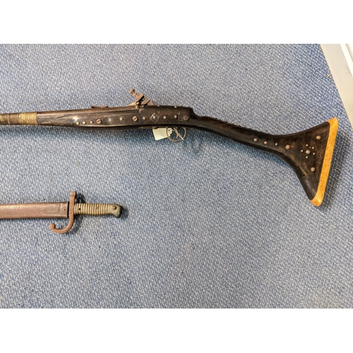 36 - A 19th century reproduction flintlock musket, along with a 19th century bayonet Location: LWF
If the... 